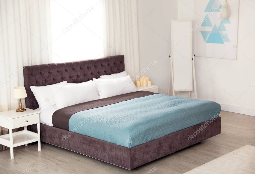 Modern comfortable bed in room. Interior design