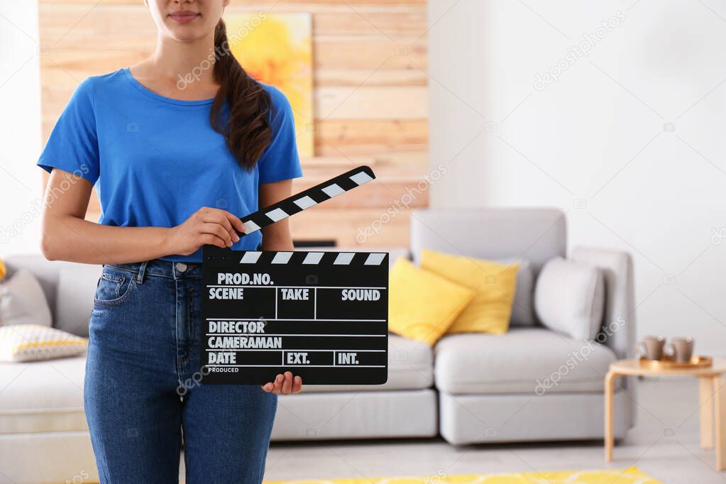 Assistant holding clapboard on film set, closeup. Space for text