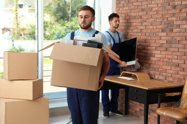 Professional workers carrying stuff out of office. Moving service