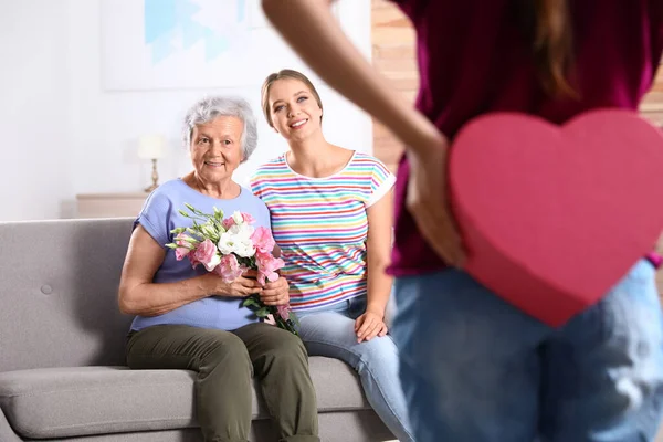Preteen girl congratulating her mom and granny at home. Happy Mother's Day — Stock Photo, Image