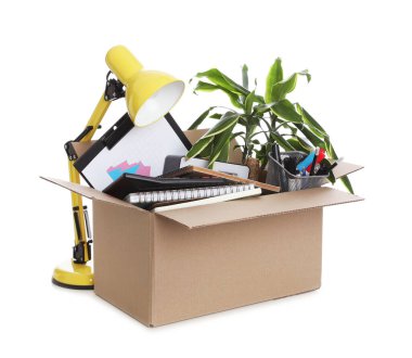 Cardboard box full of office stuff on white background clipart