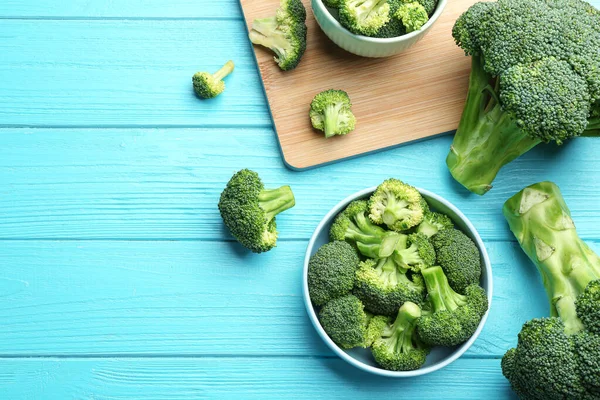 Composizione flat lay di broccoli freschi verdi sul tavolo di legno blu, spazio per il testo — Foto Stock