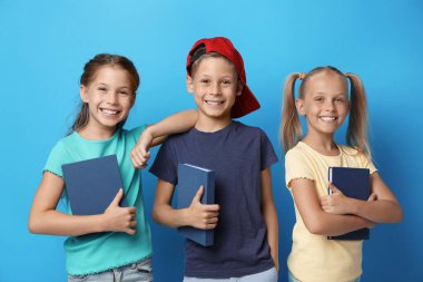 Mavi arka plan kitapları olan küçük çocuklar. Okuma konsepti