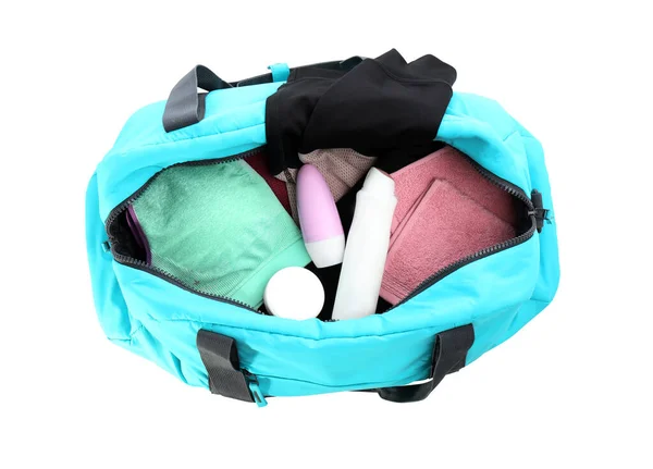 Sport bag with deodorants and clothes on white background, top view — ストック写真