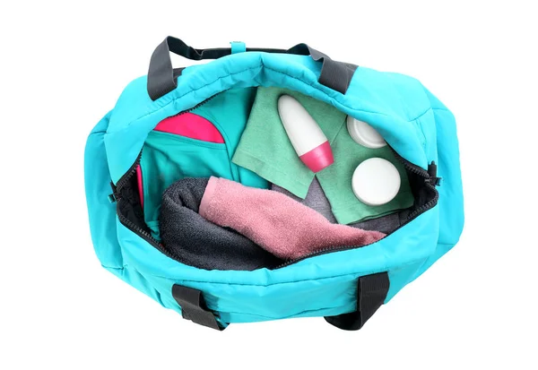 Sport bag with deodorant and clothes on white background, top view — ストック写真