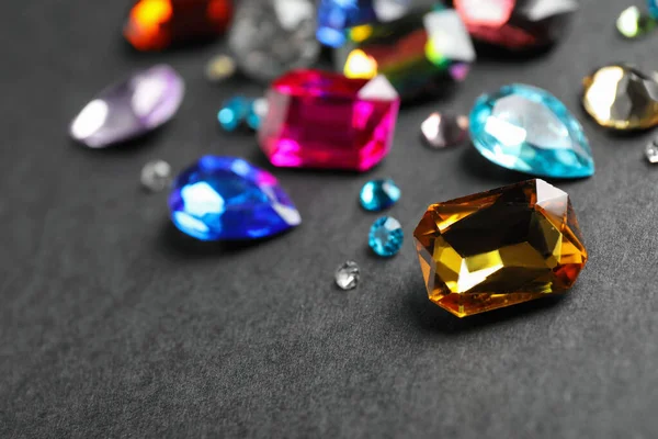 Different beautiful gemstones on black background. Space for text — Stock Photo, Image