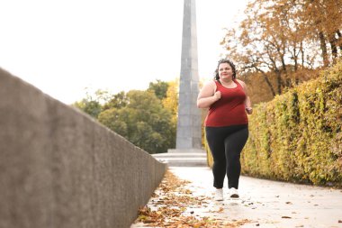 Parkta koşan güzel şişman kadın. Fitness yaşam tarzı
