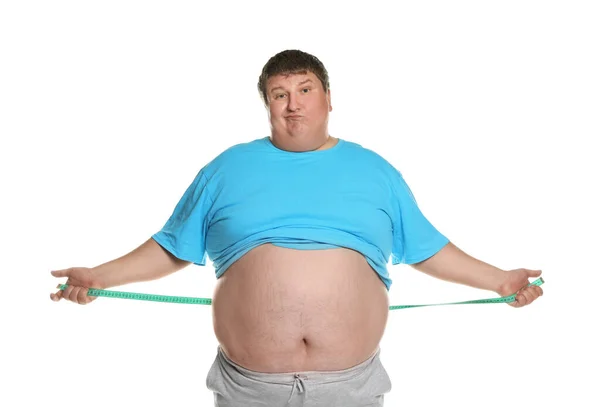 Érzelmi túlsúlyos férfi mérőszalaggal fehér háttéren — Stock Fotó