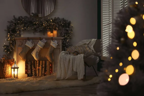 Fireplace with Christmas stockings in festive room interior — ストック写真
