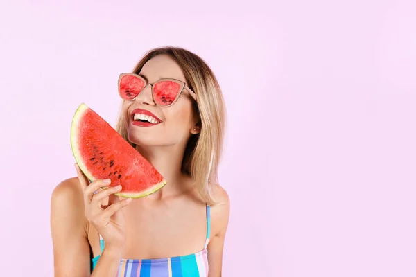 Beautiful young woman with juicy watermelon on pink background. Fruit sunglasses as summer trend — Stock Photo, Image