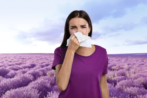 Young woman suffering from allergy and blooming lavender field on background — Stock Photo, Image