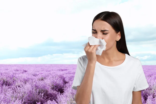 Young woman suffering from allergy and blooming lavender field on background — Stock Photo, Image