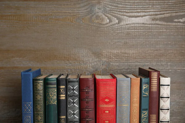 Stack of hardcover books on wooden background. Space for text — Stock Photo, Image