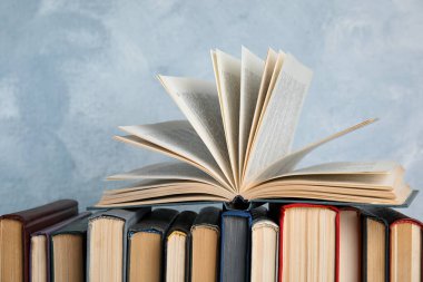 Açık mavi arkaplan üzerine kitap yığını