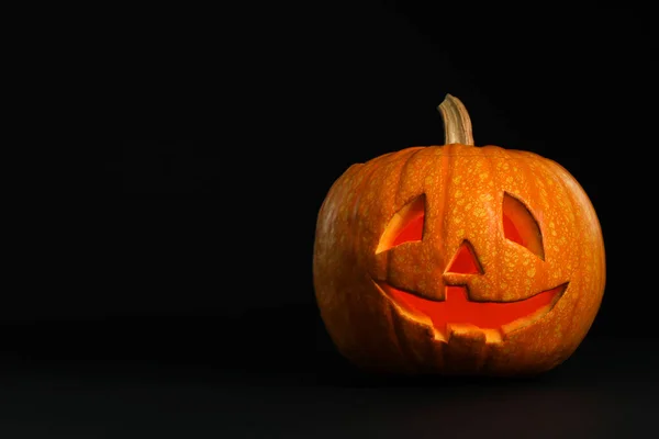 Cabeça de abóbora no fundo preto, espaço para texto. Lanterna de Jack - decoração de Halloween tradicional — Fotografia de Stock