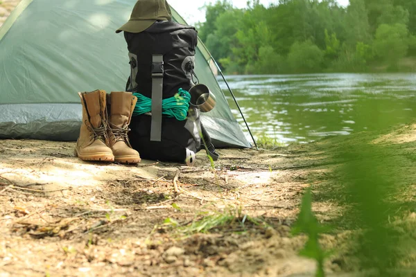 Moderna tenda da campeggio e attrezzature sulla riva del fiume. Spazio per testo — Foto Stock