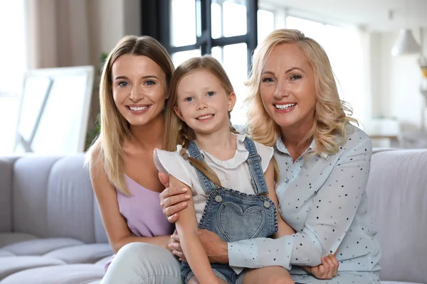 Giovane donna con madre matura e figlioletta in soggiorno — Foto Stock