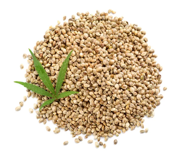 Pile of hemp seeds and leaf on white background, top view — Stock Photo, Image