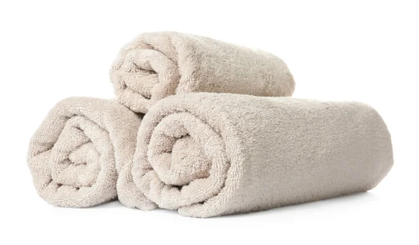 Rolled clean beige towels on white background — Stock Photo, Image