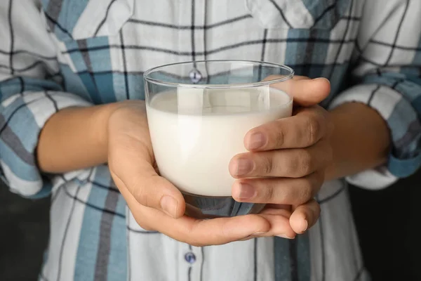 Woman holding glass of hemp milk, closeup