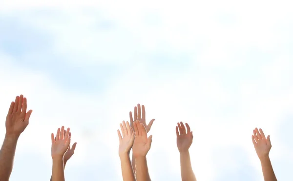 Группа волонтеров поднимает руки на открытом воздухе, крупным планом — стоковое фото