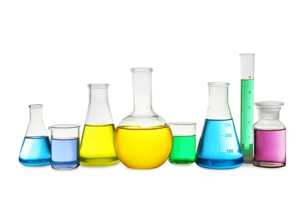 Laboratory glassware with colorful liquids on white background — Stock Photo, Image