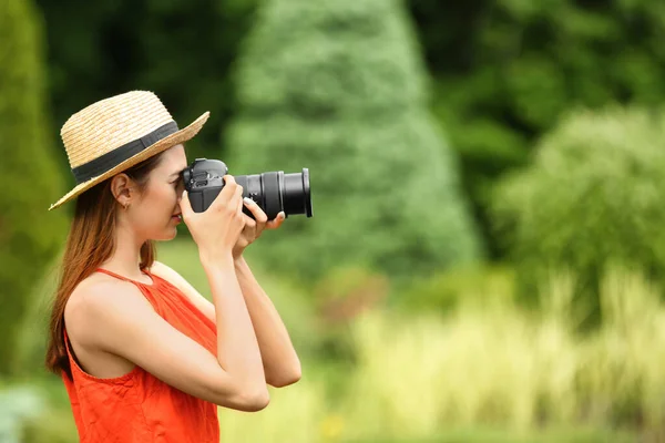 Photographer taking photo with professional camera in park — Stock Photo, Image