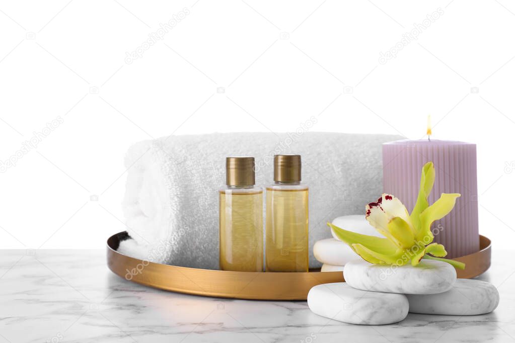 Composition with towel and spa supplies on marble table against white background