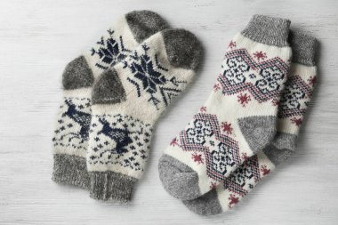 Beyaz ahşap arka plan üzerinde farklı örme çorap, düz yatıyordu