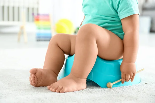 Little boy with wooden stick sitting on potty at home, closeup — Stock Photo, Image