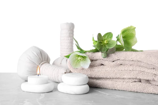 Composition with flowers and spa supplies on marble table against white background — Stock Photo, Image