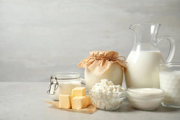 Different dairy products on light table. Space for text — Stock Photo, Image