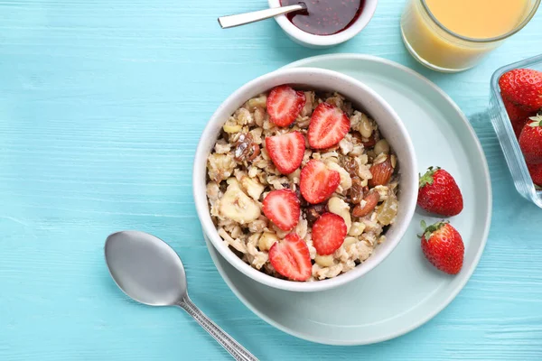 Flat lay composition with tasty muesli on light blue wooden table. Healthy breakfast — Stock Photo, Image