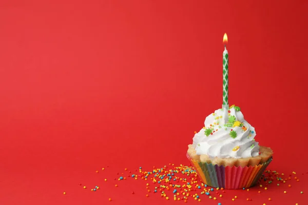 stock image Birthday cupcake with candle on red background, space for text. Greeting card
