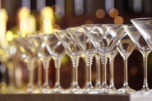 Empty martini glasses on table against blurred background Stock Picture