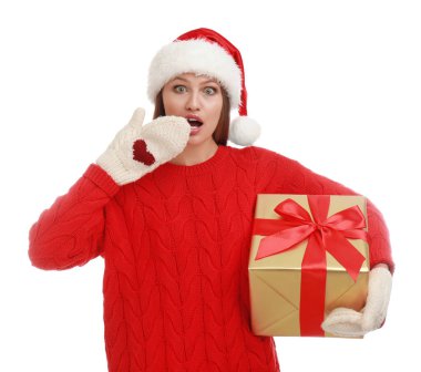 Noel Baba şapkalı, beyaz arka planda Noel hediyesi olan duygusal genç bir kadın.