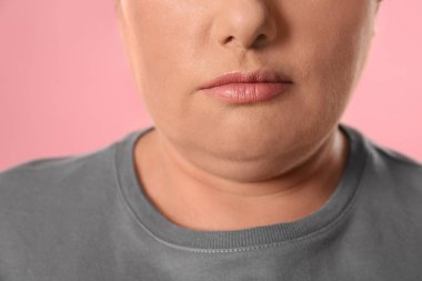 Woman with double chin on pink background, closeup clipart