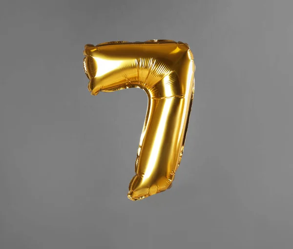 Golden number seven balloon on grey background — ストック写真