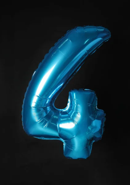 Blue number four balloon on black background — ストック写真