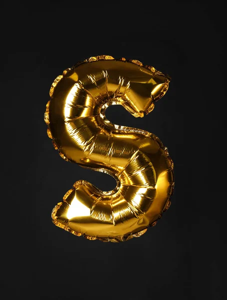 Golden letter S balloon on black background — Stock Photo, Image