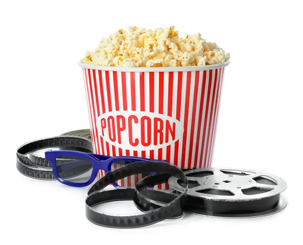 Bucket of fresh popcorn and movie reel on white background. Cinema snack — ストック写真