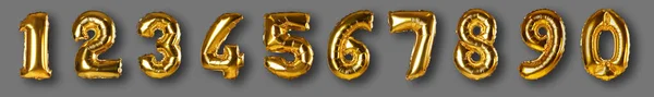 Set with golden foil balloons in shape of numbers on grey background — Stock Photo, Image