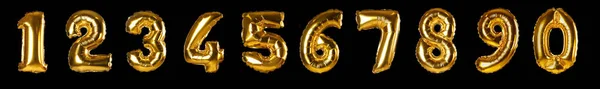 Set with golden foil balloons in shape of numbers on black background — ストック写真