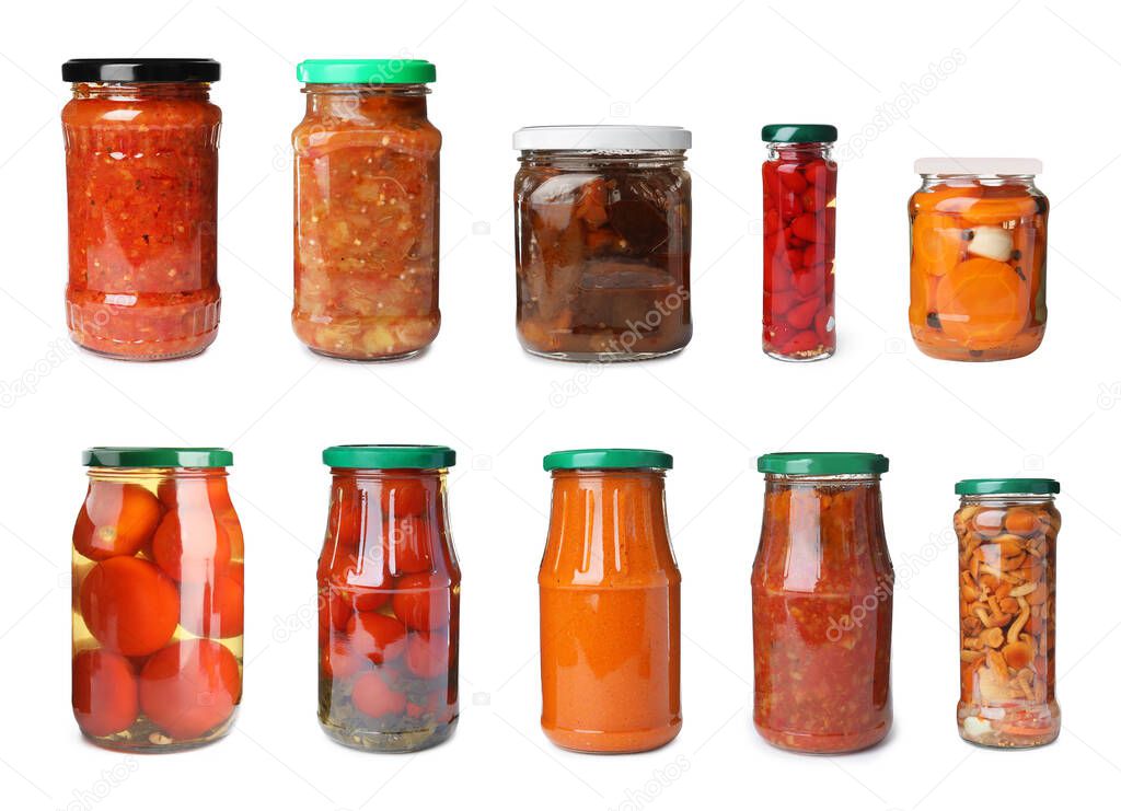Set of glass jars with different pickled vegetables on white background