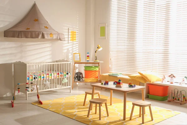 Cozy baby room interior with comfortable crib — Stock Photo, Image