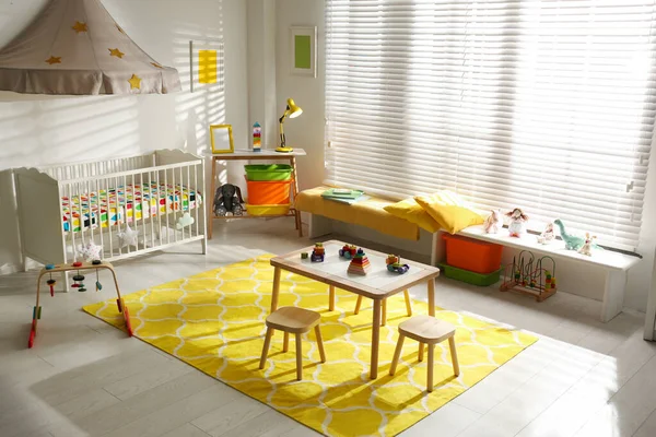 Cozy baby room interior with comfortable crib — Stock Photo, Image