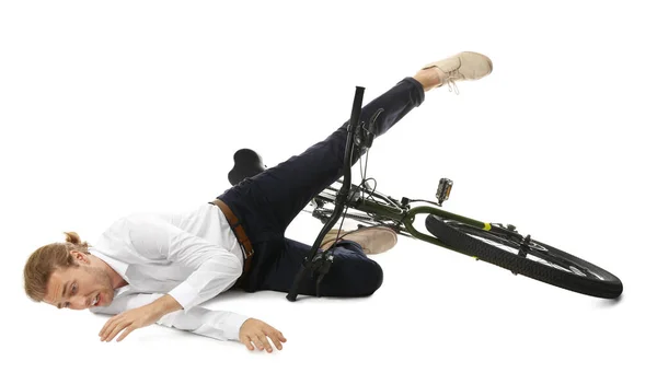 Young man falling off bicycle on white background — Stock Photo, Image