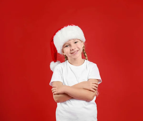 可爱的小孩戴着红色背景的圣诞老人帽. 圣诞假期 — 图库照片