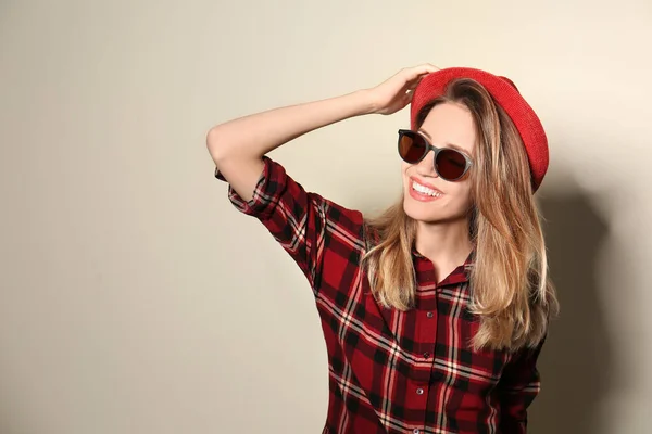 Young woman wearing stylish sunglasses on beige background. Space for text — Stock Photo, Image