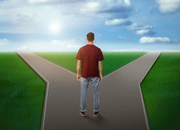 Choose your way. Man standing at crossroads taking important decision